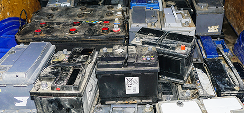 Image of aa pile of used car batteries